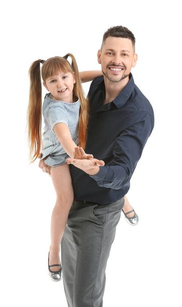 Father and his little daughter dancing against white background - Fotó, kép