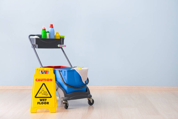 Caution sign with cleaning supplies indoors - Photo, Image