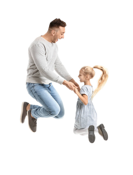 男と彼の娘は白い背景に飛び跳ねる - 写真・画像