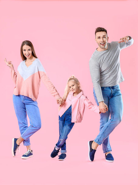 Happy family dancing against color background - Foto, afbeelding