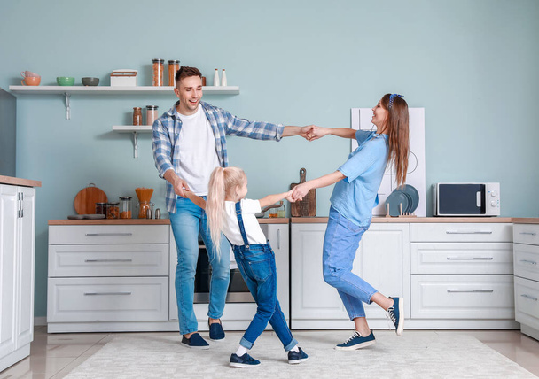 Happy family dancing in kitchen - Photo, Image