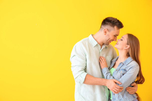 Happy young couple on color background - Foto, afbeelding