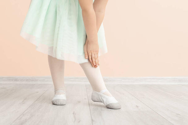 Cute little ballerina near color wall - Photo, Image