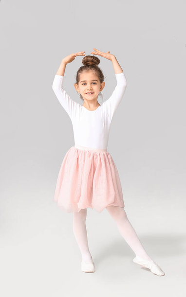 Cute little ballerina on light background - Fotó, kép