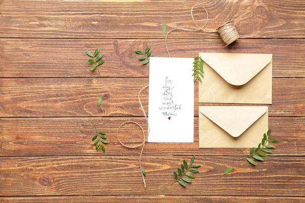 Composition with greeting card for mother on wooden background - Photo, Image