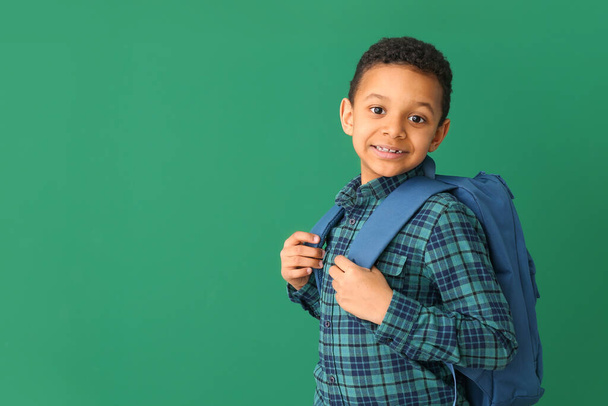 Cute African-American schoolboy on color background - Foto, Imagem