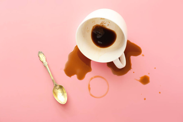 Overturned cup of coffee on color background - Φωτογραφία, εικόνα