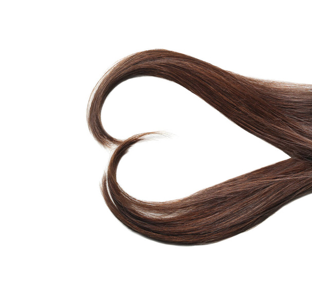 Heart made of beautiful long hair on white background - Valokuva, kuva