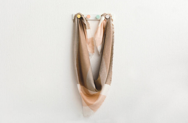 Hanger with beautiful scarf on white wall - Foto, Imagem