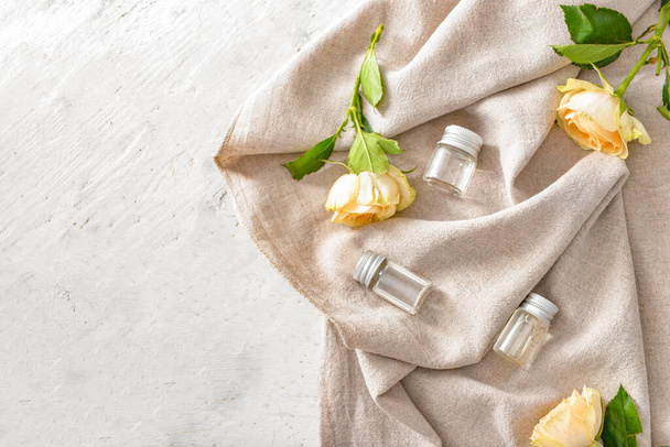 Bottles of rose essential oil on white background - Fotografie, Obrázek
