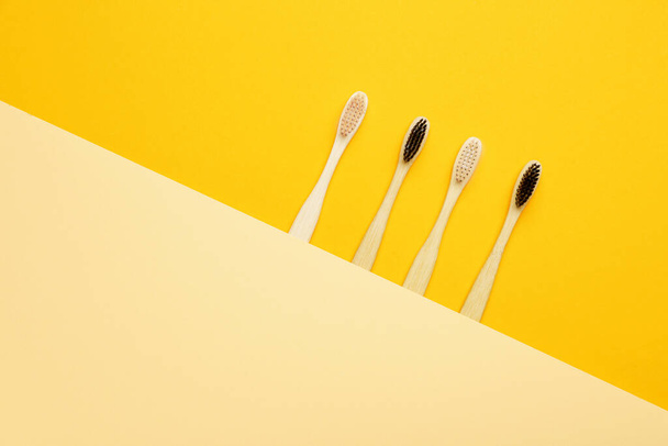 Wooden tooth brushes on color background - Photo, Image