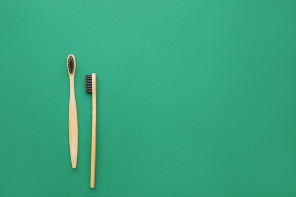Wooden tooth brushes on color background - Φωτογραφία, εικόνα