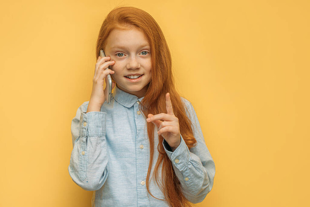 cheerful caucasian kid girl talk on phone - Valokuva, kuva