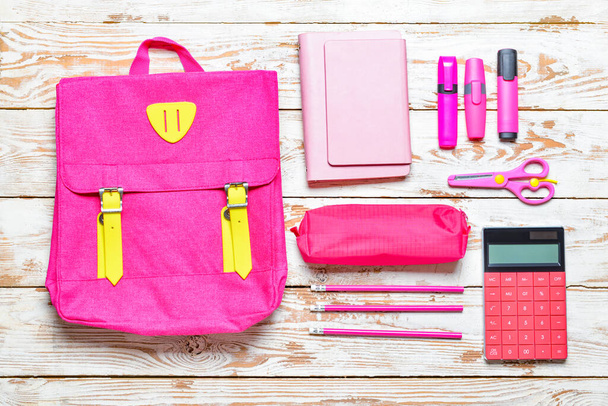 School backpack and stationery on wooden background - Photo, Image