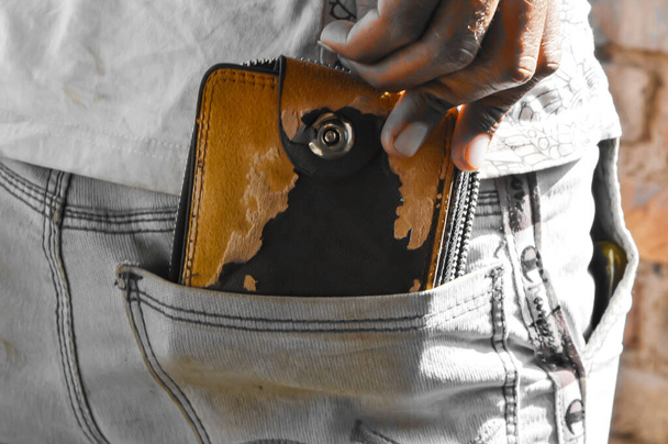  man posing in safe keeping your wallet in the back pocket of his back pocket pants. savings money finance,old pocket  close up,wallet in your back pocket - Photo, Image