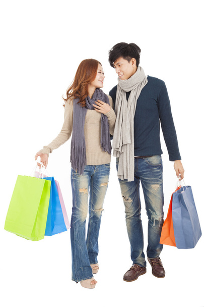 Happy couple doing shopping isolated on white - Foto, afbeelding