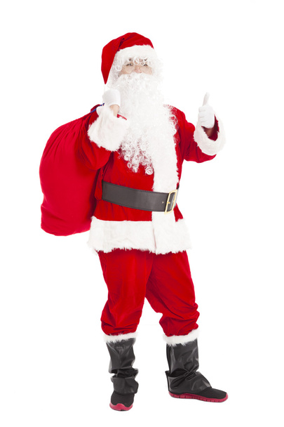 Feliz Navidad Santa Claus sosteniendo bolsa de regalo con pulgar hacia arriba
 - Foto, imagen