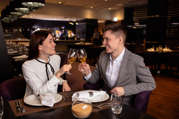 side view on couple enjoying dinner in restaurant - Valokuva, kuva
