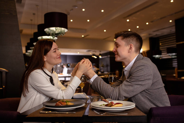 happy couple have dinner, dating in restaurant - Photo, image