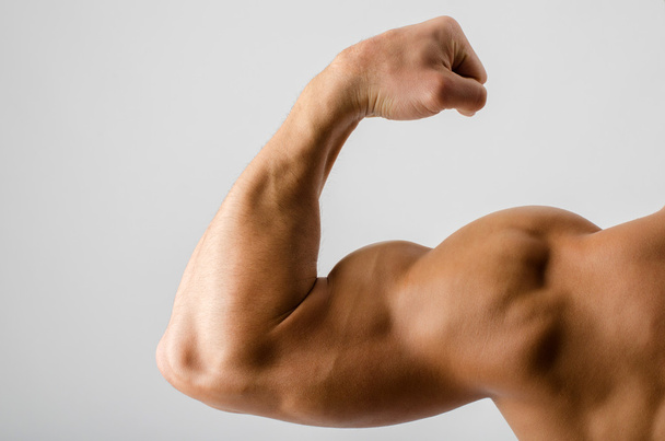 Close up on a bodybuilder biceps,shoulder,arm - Фото, изображение