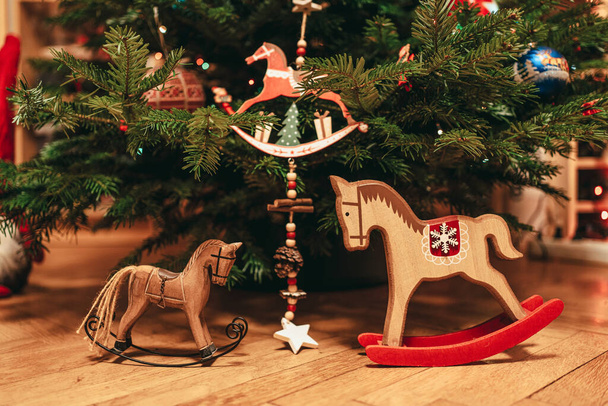 Hračkové koně dekorace pod přírodní vánoční stromeček - Fotografie, Obrázek