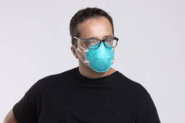 Man with spectacles in N95 surgical mask. - Photo, Image