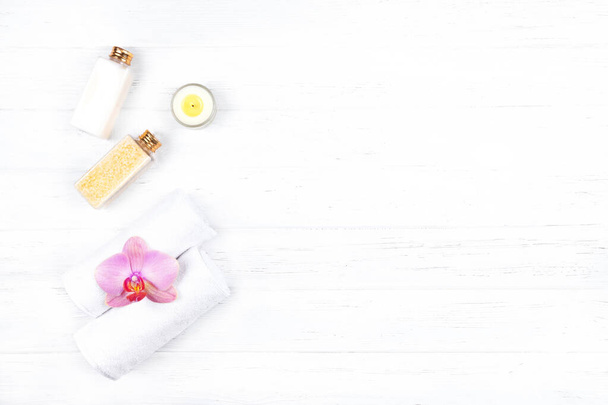 Top view of different spa, beauty and wellness products: cream, sea salt and towels with copy space. Beauty and wellness concept. Flat lay. - Photo, Image