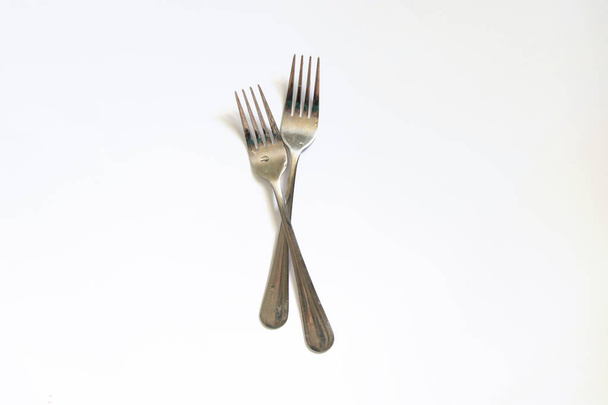 table forks lie on a white background close-up - Fotoğraf, Görsel