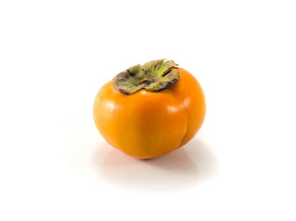 Isolated persimmon fruit on the white background - Photo, Image