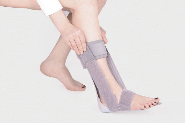Orthopedic Ankle Brace. Medical Ankle Bandage. Medical Ankle Support Strap Adjustable Wrap Bandage Brace foot Pain Relief Sport. Leg Brace isolated on white background - Фото, изображение