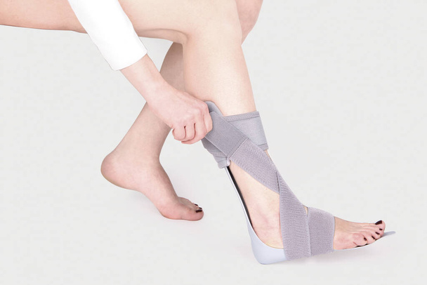 Orthopedic Ankle Brace. Medical Ankle Bandage. Medical Ankle Support Strap Adjustable Wrap Bandage Brace foot Pain Relief Sport. Leg Brace isolated on white background - Photo, image
