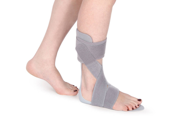 Orthopedic Ankle Brace. Medical Ankle Bandage. Medical Ankle Support Strap Adjustable Wrap Bandage Brace foot Pain Relief Sport. Leg Brace isolated on white background - Fotó, kép