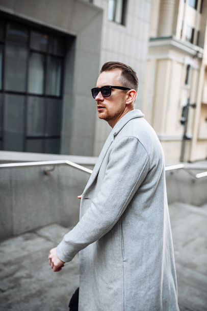 Portrait of a handsome man in coat and sunglasses - Fotografie, Obrázek
