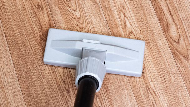Vacuum cleaner brush on a wooden floor close up, copy space - Photo, Image