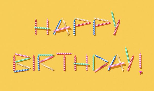 Congratulation card with text Happy Birthday handmade from multicolored candles on a yellow background, copy space. - Photo, Image