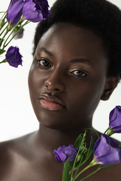nude african american girl with purple eustoma flowers isolated on white - Fotoğraf, Görsel