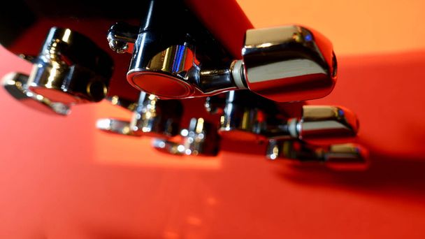 guitar headstock closeup . Red background - Foto, immagini