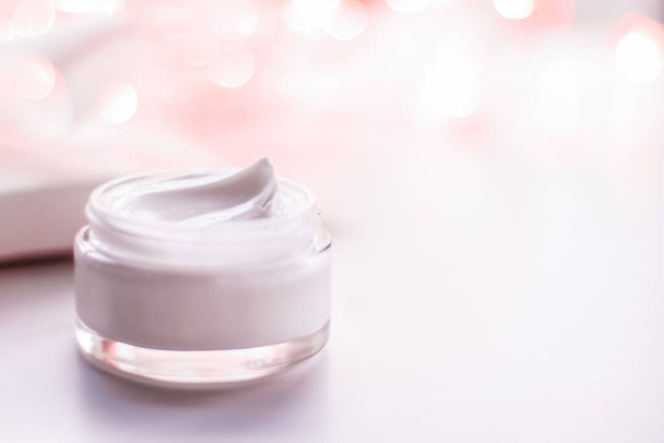Facial cream moisturizer jar on holiday glitter background, anti-age skin care product - Valokuva, kuva
