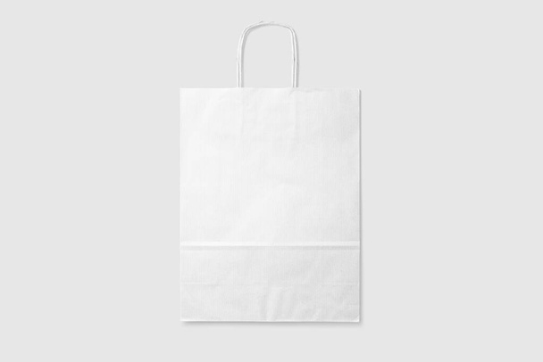 Mockup of a blank white paper shopping bag with handles on light grey background. High resolution. - Photo, Image