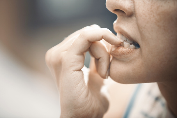 Woman in stress gnawing her nails - Φωτογραφία, εικόνα