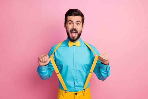 Portrait of his he nice attractive funky excited cheerful cheery glad imposing well-dressed bearded guy wearing mint blue shirt pulling suspenders having fun isolated over pastel pink color background - Foto, Imagem