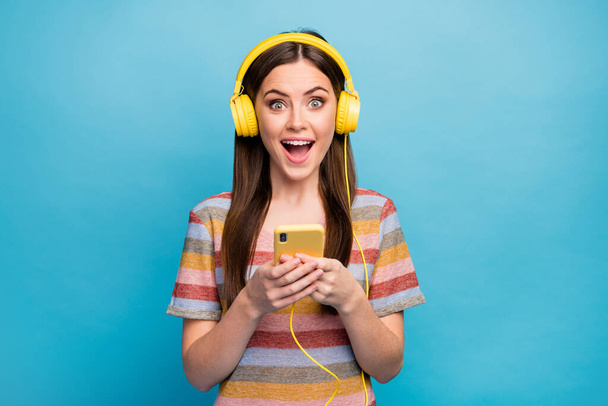 Close-up portrait of her she nice lovely pretty charming cute winsome cheerful cheery girl listening radio melody spending free spare time isolated on bright vivid shine vibrant blue color background - Foto, Imagen