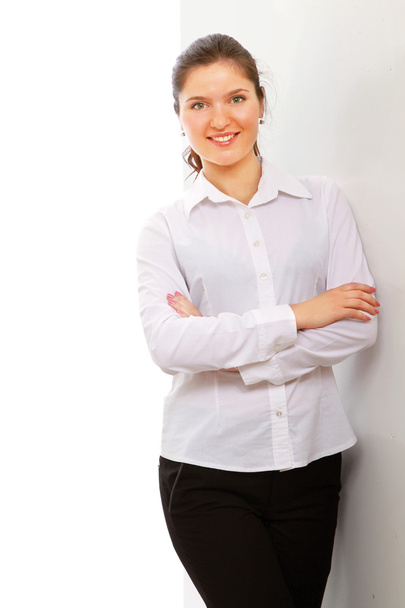 A businesswoman standing near the wall - Photo, Image