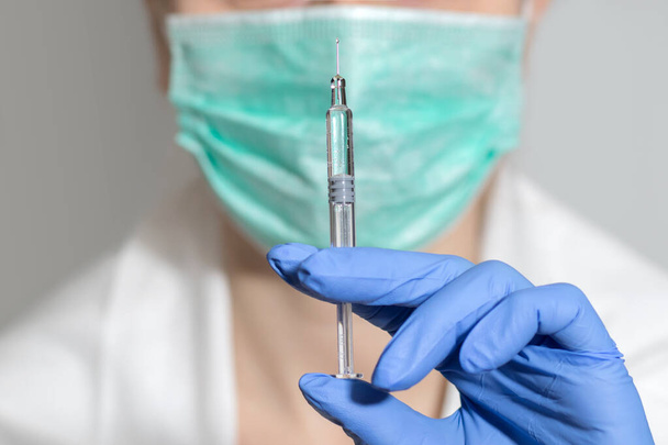 healthcare and medical concept - close up of female doctor holding syringe with injection. - Photo, Image