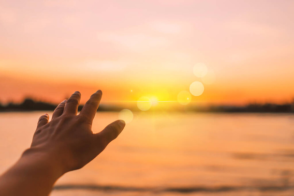 Woman hand reach out to sky like praying in front of sky background - Fotoğraf, Görsel