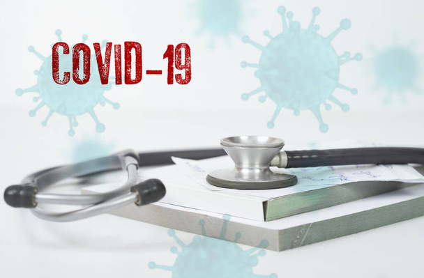 Concept of COVID-19 - Coronavirus disease - 2019-nCoV, WUHAN corona virus. Stethoscope close up photo.The inscription coronovirus COVID-19 - Foto, immagini