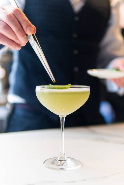 cropped shot of bartender making cocktail in bar - 写真・画像