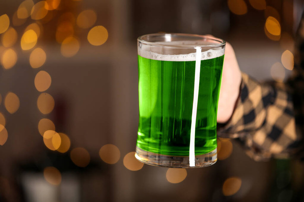 Closeup view of man with green beer in pub, space for text. St.Patrick's Day celebration - Φωτογραφία, εικόνα