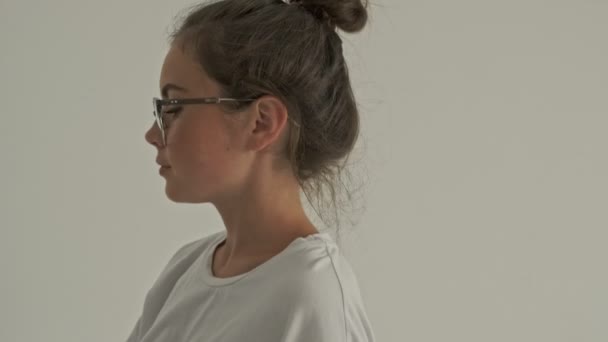 Calm pretty brunette woman in eyeglasses taking bottle of milk from refrigerator and going away at home - Séquence, vidéo