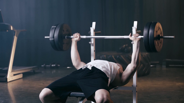 athletic sportsman weightlifting barbell in gym  - Footage, Video
